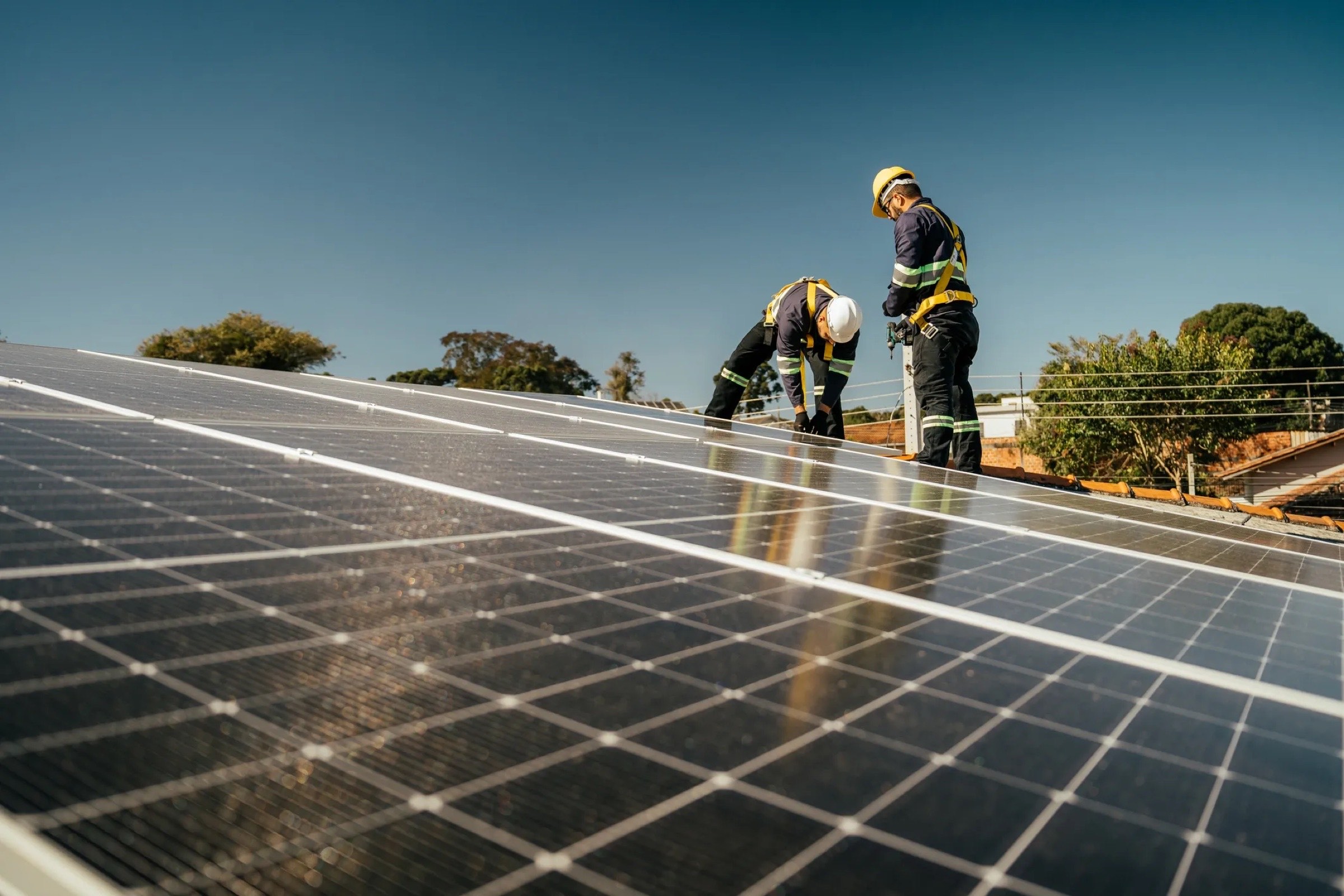 Crew installing solar panels on a roof